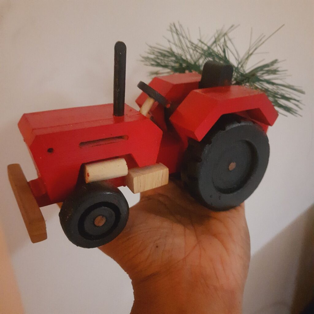 the red tractor is the perfect Christmas piece of vehicle decor for Indian homes