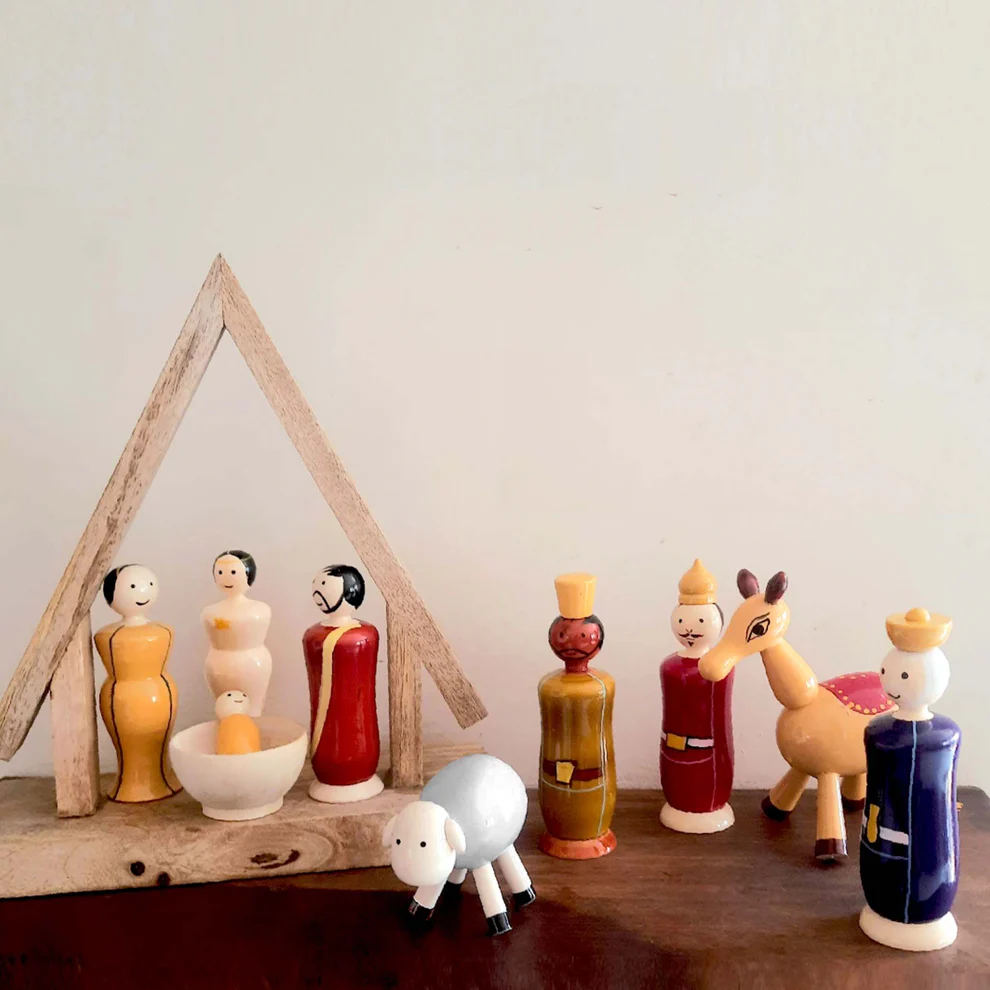 A unique Nativity Set, with Mary, Joseph, Baby Jesus and the 3 Kings, plus an angel, camel and sheep all creatively represented in the Etikoppaka art form | Indian Christmas Decor